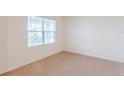 Bright bedroom with carpeted floors and large window at 460 Boardwalk Ave, Haines City, FL 33844