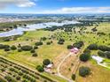 Aerial view of a home on a large lot with a lake nearby at 2741 Edwards Rd, Haines City, FL 33844