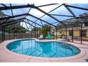 Inviting kidney-shaped pool with a screened enclosure at 122 Bishop St, Auburndale, FL 33823