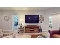 Living area showcasing a large TV and comfortable seating at 1067 Snively Cir, Lake Hamilton, FL 33851