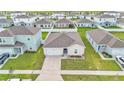 Aerial view of a house and surrounding neighborhood, showcasing landscaping and a driveway at 1422 Madison Cir, Haines City, FL 33844