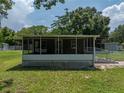 A house with a large screened porch, perfect for outdoor relaxation at 14813 Camp Mack Rd, Lake Wales, FL 33898