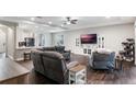 Open-concept living room with comfortable seating, a large TV, and views of the adjacent kitchen at 329 Lake Vista Dr, Auburndale, FL 33823
