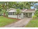 Updated home with a screened porch, carport, and lush landscaping at 1165 E Church St, Bartow, FL 33830