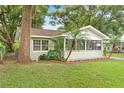 Renovated home nestled among mature trees, featuring a screened porch at 1165 E Church St, Bartow, FL 33830