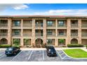 Building exterior with stone accents and multiple balconies at 902 Charo Pkwy # 624, Davenport, FL 33897