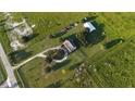 Aerial view of a house on a large property with barns and fields at 3390 Lake Buffum Rd E, Fort Meade, FL 33841