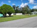 Landscaped lot with fenced yard and mature trees at 1020 York St, Haines City, FL 33844