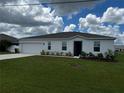 Newly built home with a two-car garage and neatly landscaped yard at 177 Cimarron Ln, Kissimmee, FL 34759