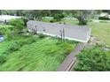 Single wide manufactured home with overgrown backyard at 1815 Christy Ln, Lakeland, FL 33801