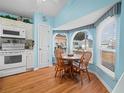 Eat-in kitchen with wood flooring and view to backyard at 716 Challenger Ave, Davenport, FL 33897