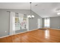 Bright dining room with hardwood floors and vaulted ceiling at 816 W Hancock St, Lakeland, FL 33803