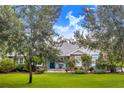 One-story home with blue exterior and landscaped yard at 2931 Chickasaw Cir, Haines City, FL 33844