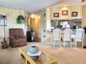 Open kitchen with breakfast bar and access to living area at 191 Sweet Cir, Winter Haven, FL 33884