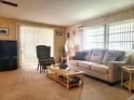 Living room with sofa, chair, coffee table, and TV at 191 Sweet Cir, Winter Haven, FL 33884
