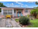 Ranch style home with pink exterior, small front yard, and driveway at 512 N 4Th St, Haines City, FL 33844