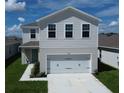 Two-story house with a two-car garage and a neatly landscaped yard at 5031 Starboard St, Haines City, FL 33844
