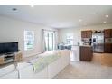 Open living room and kitchen area with neutral colors and modern furniture at 5031 Starboard St, Haines City, FL 33844