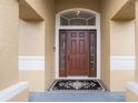 Elegant front door entrance with a decorative doormat at 608 Hatchwood Dr, Haines City, FL 33844