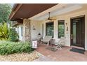 Inviting front porch with seating area and decorative landscaping at 14 Pilot Pl, Winter Haven, FL 33881