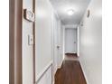 Clean hallway with dark wood floors and doors leading to other rooms at 3050 Cross Fox Dr, Mulberry, FL 33860