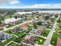 Aerial view of houses, lakefront property, and community at 302 Ruby Lake Ln, Winter Haven, FL 33884