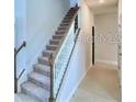 Modern staircase in the hallway of a new construction home at 1476 Leamington Lane, Winter Haven, FL 33884