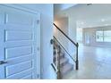 Elegant staircase leading to the upper level of the home at 1476 Leamington Lane, Winter Haven, FL 33884