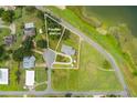 Aerial view showing a single story home with a possible second lot and lake access at 405 W 4Th Ct, Frostproof, FL 33843