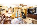 Cozy game room with leather seating, large screen TV, and musical instruments at 4822 Melody Ln, Lakeland, FL 33805