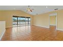 Bright living room with tile floors and access to a balcony at 3038 Spirit Lake Dr, Winter Haven, FL 33880
