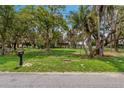 Landscaped lot with a lake view and mature trees at 3038 Spirit Lake Dr, Winter Haven, FL 33880