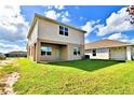 Two-story house back with large backyard and covered patio at 1480 Leamington Lane, Winter Haven, FL 33884