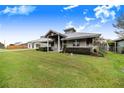 Charming home with metal roof, landscaping, and spacious yard at 29 Turtle Ln, Haines City, FL 33844