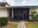 Condo entrance with screened porch and landscaping at 2049 San Marcos Se Dr # 127, Winter Haven, FL 33880