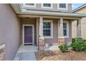 Front entry with a purple door and stone accents at 3540 Julius Estates Blvd, Winter Haven, FL 33881