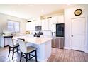 Modern kitchen with white cabinets, stainless steel appliances, and an island at 1011 Overlook Ct, Davenport, FL 33837