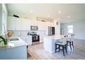 Modern kitchen with white cabinets, stainless steel appliances, and an island at 1011 Overlook Ct, Davenport, FL 33837