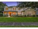 Two-story house with landscaped yard, lit at dusk at 2433 Home Again Rd, Apopka, FL 32712