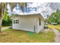 Side view of a white single-story house with green grass at 4590 San Heath Rd, Bartow, FL 33830