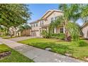 Two-story house with double garage, paver driveway and landscaping at 1114 Blackwolf Run Rd, Davenport, FL 33896