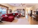 Spacious living room with red sectional sofa and hardwood floors at 708 Canberra Rd, Winter Haven, FL 33884