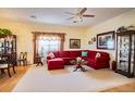 Bright living room featuring a red sectional sofa and hardwood floors at 708 Canberra Rd, Winter Haven, FL 33884