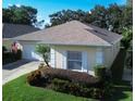 Single-story home with landscaped yard and attached garage at 708 Canberra Rd, Winter Haven, FL 33884