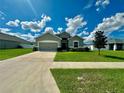 House exterior featuring gray siding and landscaping at 991 First Dr, Eagle Lake, FL 33839