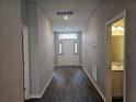 Hallway with dark flooring and access to rooms at 991 First Dr, Eagle Lake, FL 33839