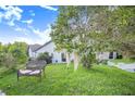 Backyard with a wicker bench and lush landscaping at 34415 Kingfish St, Fruitland Park, FL 34731