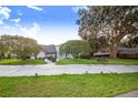 Landscaped front yard with a boat parked on the side at 34415 Kingfish St, Fruitland Park, FL 34731