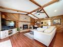 Spacious living room featuring a brick fireplace and wood beams at 4726 Monterey Dr, Winter Haven, FL 33880