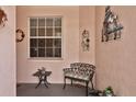 Inviting front porch with a bench and charming decor at 35 Enclave Dr, Winter Haven, FL 33884